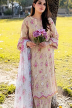 Woman in a floral dress holding flowers in an outdoor setting