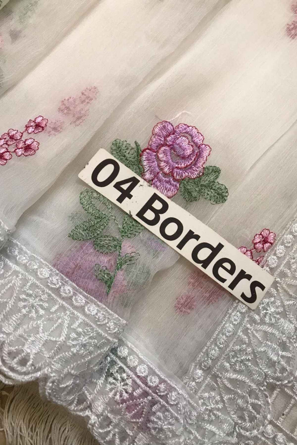 Embroidered fabric with floral designs and '04 Borders' label