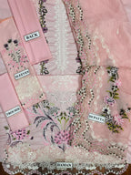 Pink embroidered fabric set with labels for dhoti, dupatta, and sleeves on a pink background.