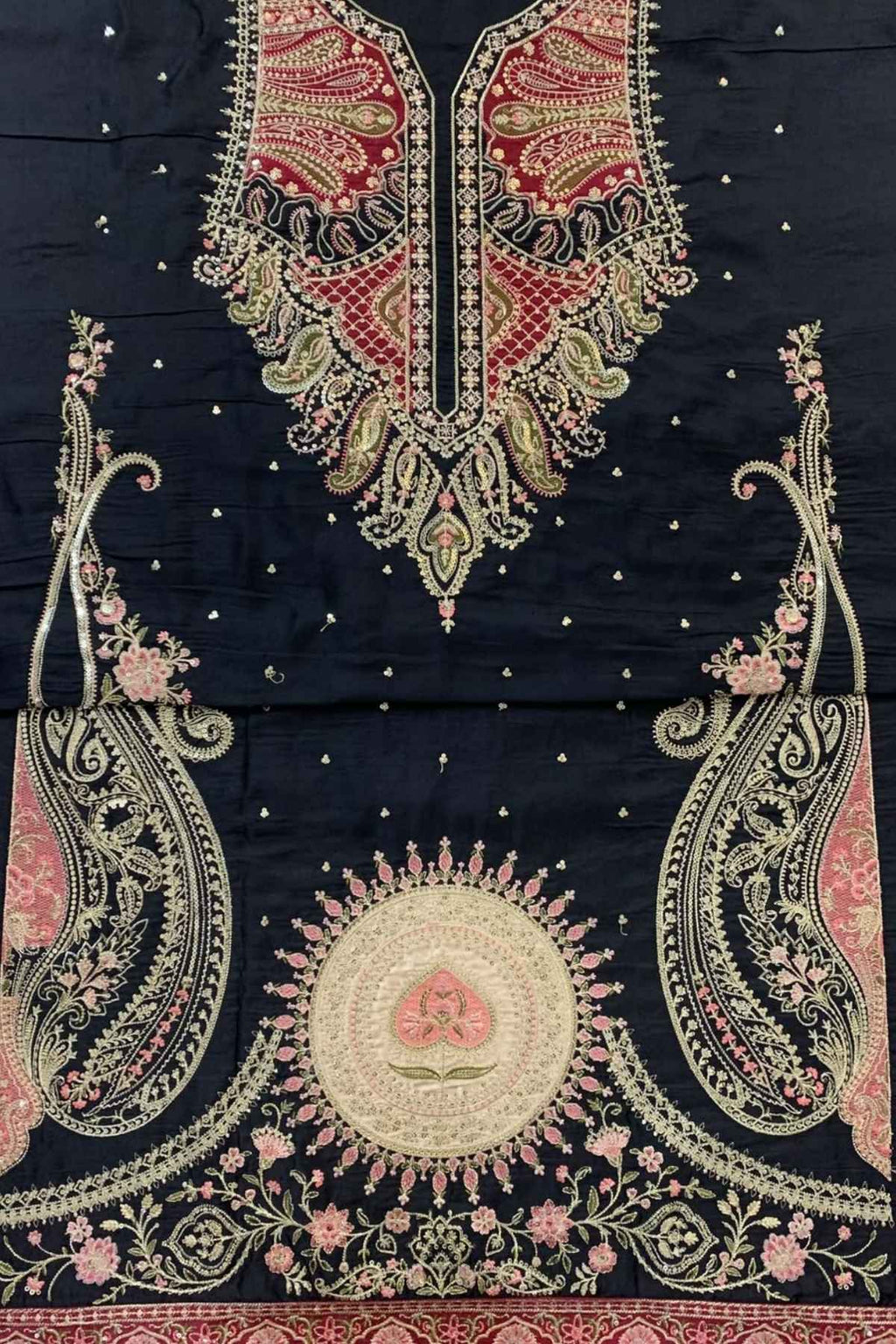 Black cotton fabric suit material featuring intricate gold, pink, and red embroidery with a large mandarin collar, paisley motifs, and a central circular floral design.