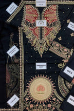 Black embroidered traditional kurta laid flat, showing the front, neck, sleeves, and back panels. The kurta features intricate gold, red, and pink floral and paisley embroidery with white labels indicating different sections.