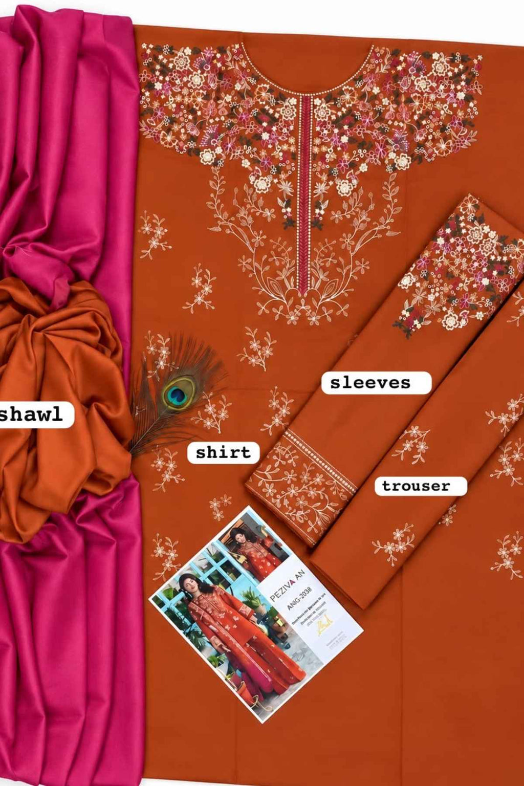 A flat-lay presentation of a traditional Indian salwar suit set in rust orange, featuring a printed kurta with floral embroidery, matching printed sleeves and trouser, a vibrant magenta pink shawl, and a decorative peacock feather. White labels identify the components: 'shirt', 'sleeves', 'trouser', and 'shawl'.