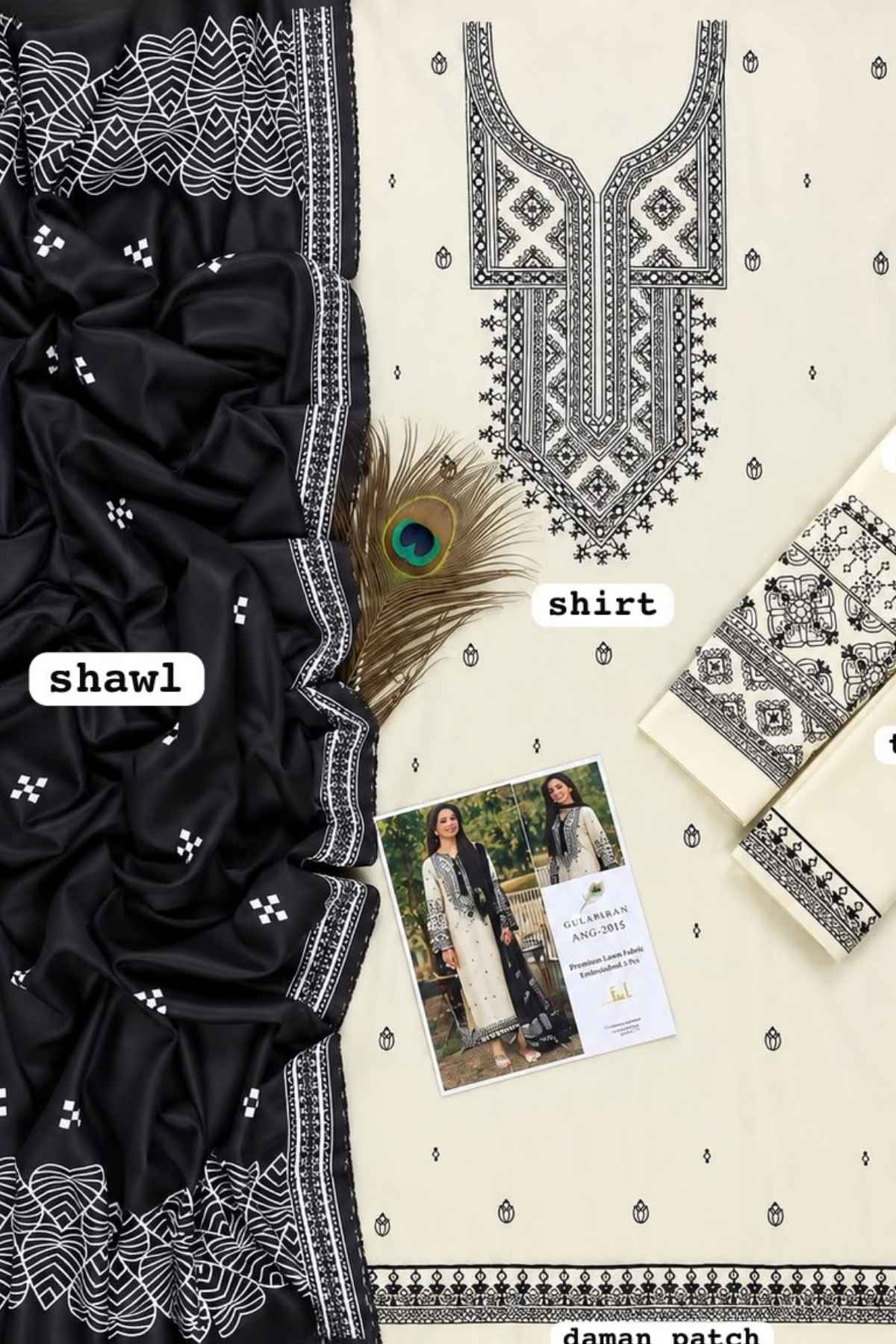 A flat-lay presentation of a traditional South Asian salwar suit set, featuring a cream-colored kurta with black geometric embroidery, a solid black shawl with white borders, and matching embroidered fabric pieces. A peacock feather and a small printed card are styled on top.
