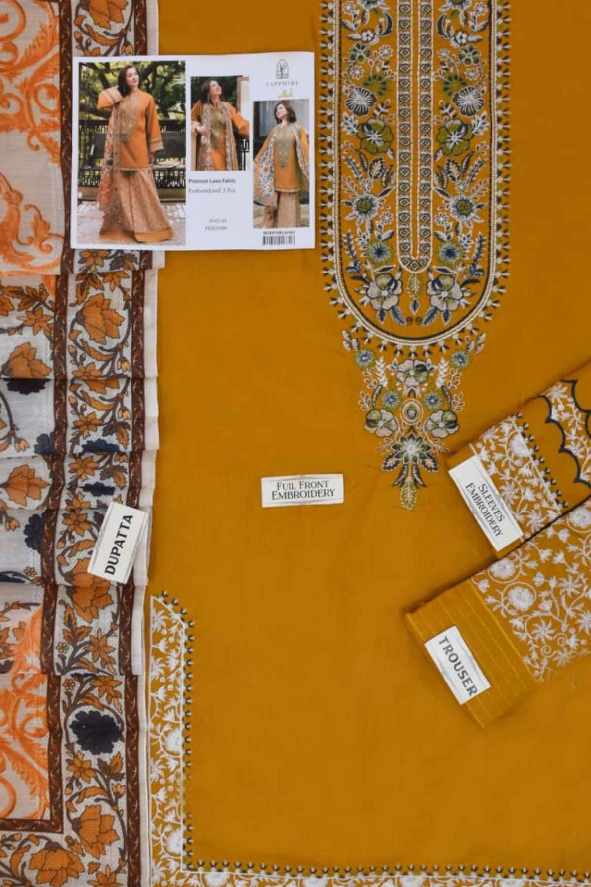 Mustard yellow fabric with intricate embroidery and brand labels