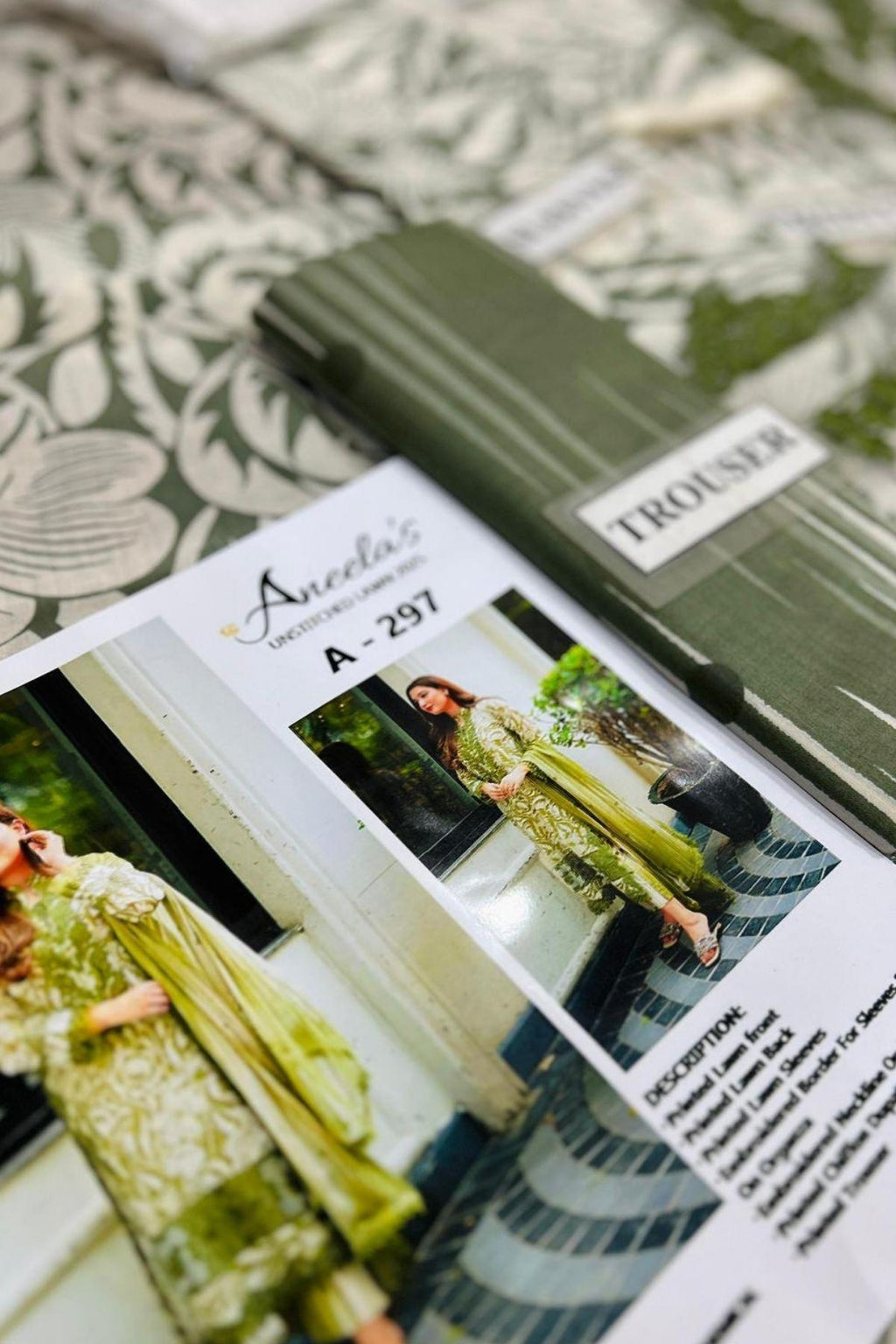 Product packaging with a label and images of a garment on a patterned fabric background
