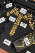 Black embroidered kurta set with gold floral embroidery, labeled parts including chevron dupatta, embroidered neck, adda work, front, and silk trouser, arranged on a dark surface.