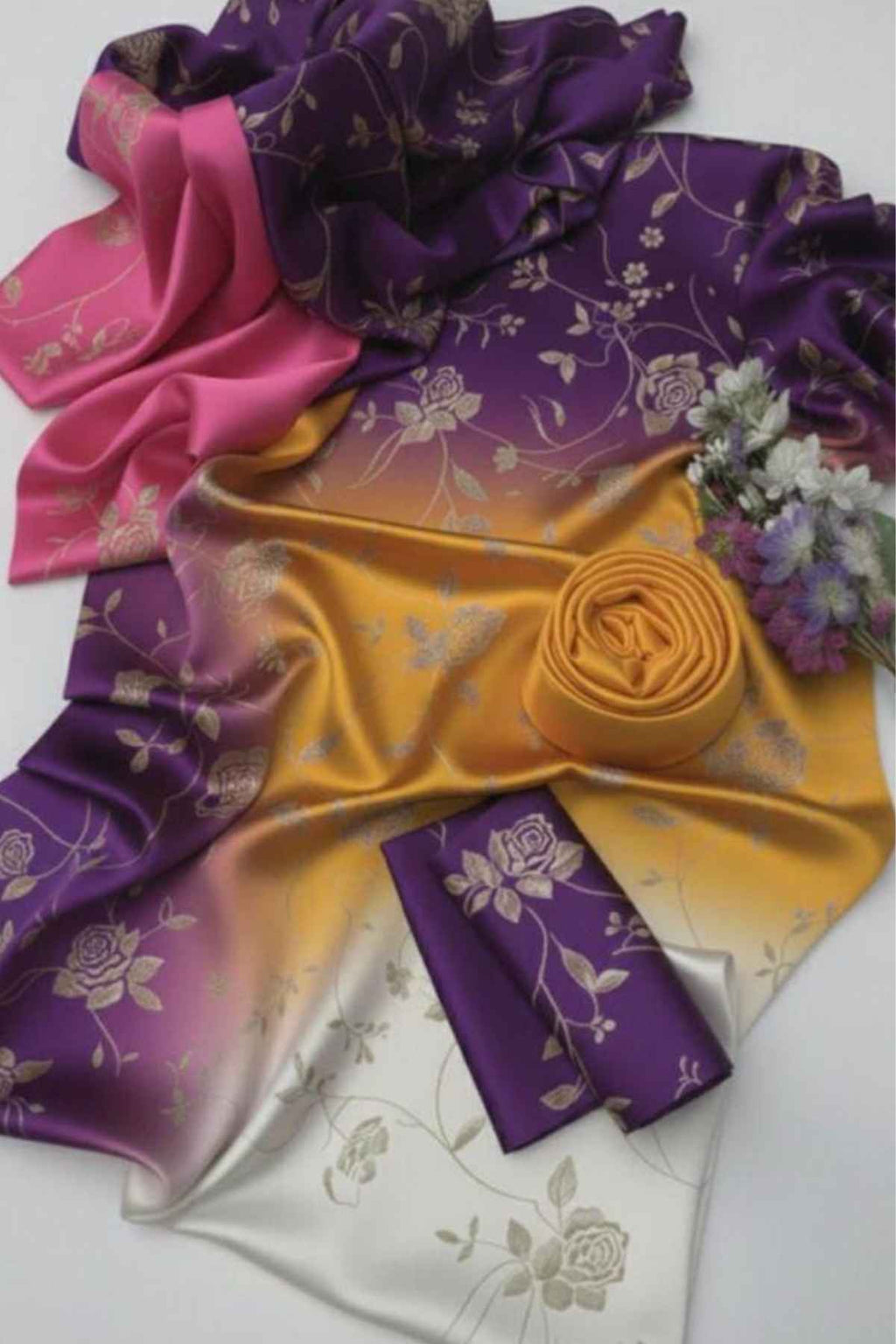 Colorful satin fabric with floral patterns on a white background