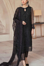Woman wearing a black embroidered outfit in an elegant interior setting